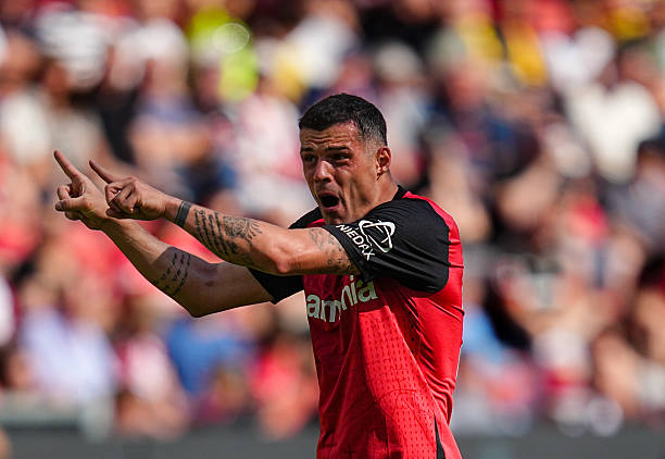 Granit Xhaka giving tactical instructions during a Bayer Leverkusen match